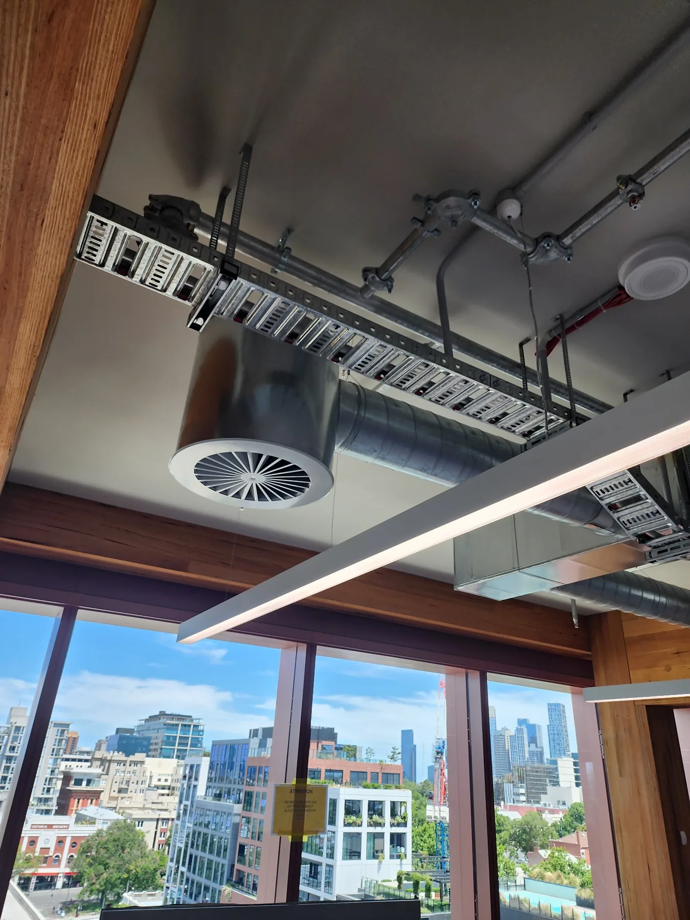 Circular diffuser and exposed ductwork in office